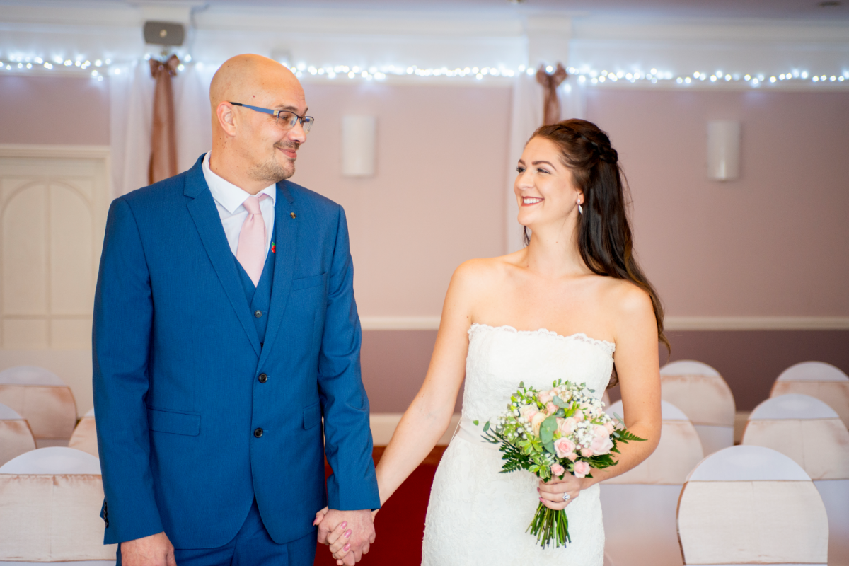 bride and groom smiling in suite.